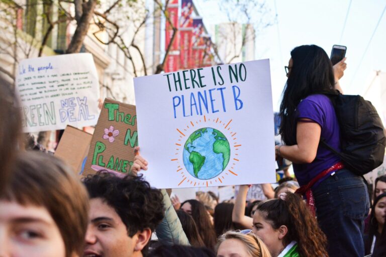 Person holding 'There is No Planet B' poster
